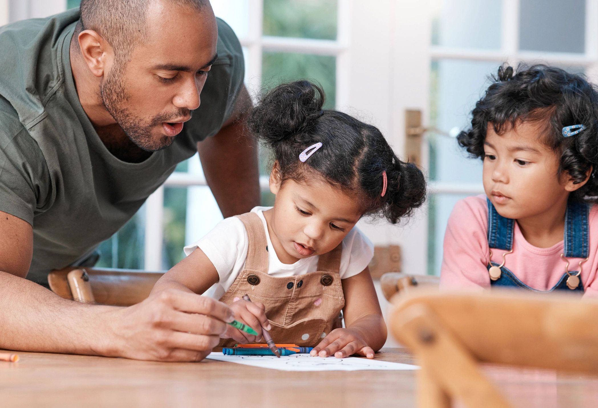 Parent and children together at home representing shared family record keeping