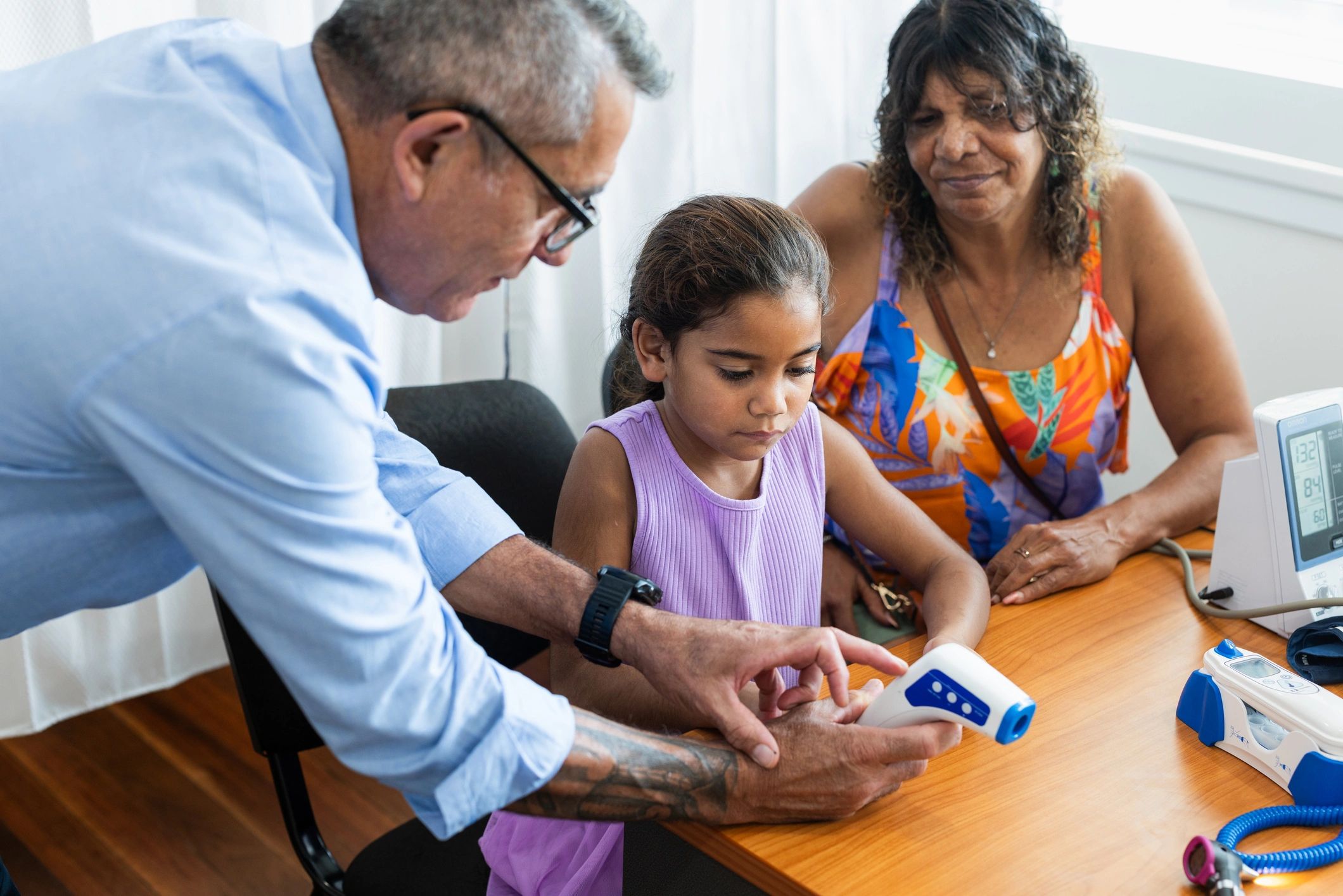 Child at a doctor visit with family support